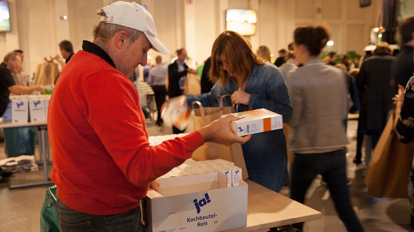 Employees in Germany fill bags with food for a local food bank